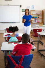 Wall Mural - African american female teacher teaching students in the class at elementary school