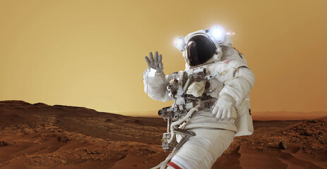 Poster - Astronaut in a space suit and a helmet with light stands on the red planet Mars greets and waves his hand. Welcome to Mars concept. Space man travels