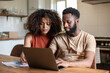 © ReeldealHD images - African american couple working on finance application together