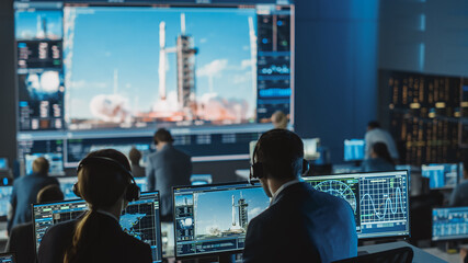 group of people in mission control center witness successful space rocket launch. flight control emp