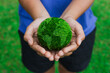 Women hands holding earth on green background. Save and protection Earth.Concept of the environment World Earth Day..