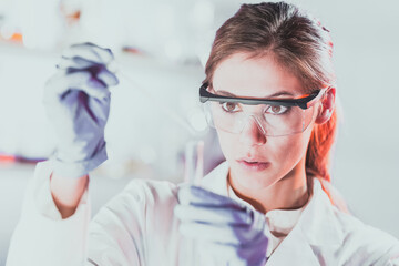 Poster - Young scientist pipetting in life science laboratory.