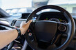 © Vatcharachai - A man's hand handle steering wheel car for driving
