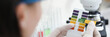 © H_Ko - Researcher holds Ph test strip for research.
