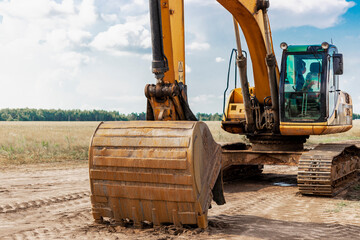 a heavy crawler excavator with a large bucket is getting ready for work. heavy construction equipmen