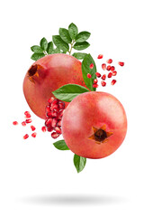 Wall Mural - A ripe pomegranate with seeds and leaves flying in the air. Isolated object on a white background. Background with pomegranate fruit. Levitate.