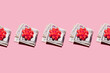 © Gemma Ferrando/Westend61 - Studio shot of row of folded dollar bills with red gift bows