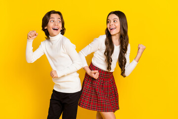 Sticker - Photo portrait of small kids smiling gesturing like winners isolated on bright yellow color background