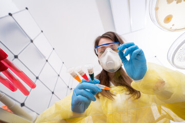 Canvas Print - Young woman with a microtube for PCR test