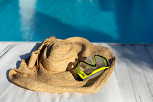 Swimming goggles on jute hat at poolside
