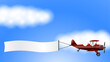 © Михаил Соколов - red biplane with a ribbon. sky and clouds