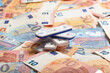 © Mimafoto/Westend61 - Rapid diagnostic tests lying on top of pile of money symbolizing making business thanks to COVID-19 pandemic