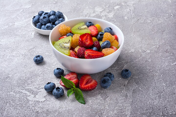 Wall Mural - Bowl of healthy salad with fresh fruits and berries