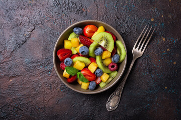 Wall Mural - Bowl of healthy salad with fresh fruits and berries