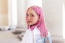Portrait Of A Positive Pink-haired Teenage Girl In A White T-shirt.Street Style.Summer Concept.Generation Z Style.Copy Space For Text.