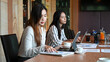 © Prathankarnpap - Two young businesswoman sitting in meeting room.