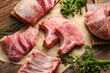 © Pixel-Shot - Slices of raw pork meat and parsley on wooden background