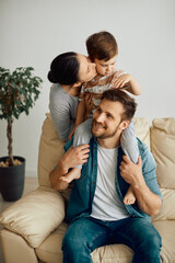 Wall Mural - Young family enjoys the time they spend together at home.