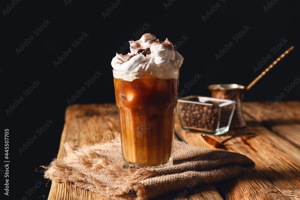 Glass of iced coffee on wooden table - obrazy, fototapety, plakaty 