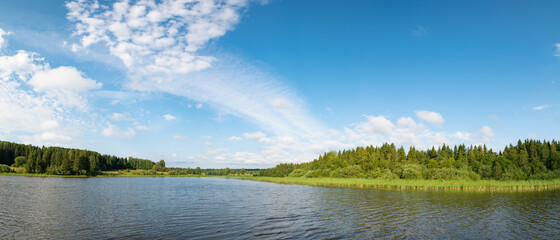 Wall Mural - panoramic landscape of a calm river. reflection of clouds on the lake.