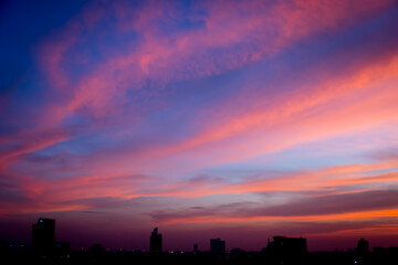 Wall Mural - Blur image of Sunset sky with city in the shadow