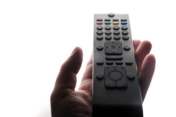 Hand holding tv remote isolated on white background.