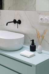 Close-up on stylish decorations next to modern washbasin