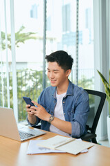 Wall Mural - Young asian business men working with laptop phone in coffee shop cafe.