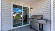 Pano Exterior of a house with a sliding glass door and vinyl sidings