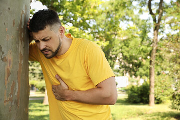 Man suffering from heat stroke in park