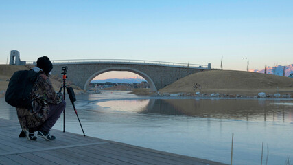 Wall Mural - Pano Docks of a river where a person is on it and taking a record of the place with a tripod.