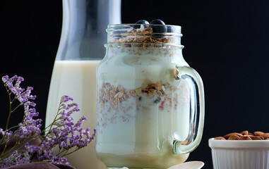 Closeup shot of healthy breakfast with milk and snacks on a decorated table