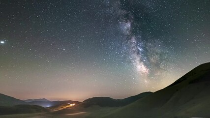Wall Mural - time lapse: night sky over castelluccio di norcia highlands, italy. the milky way galaxy and stars a