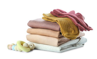 stack of baby clothes and teether on white background