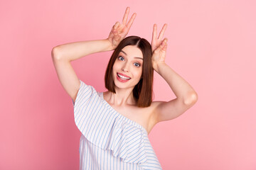 Sticker - Photo of young excited girl happy positive show fingers peace cool v-sign ears isolated over pink color background