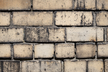 Old, dirty and weathered yellow brick wall