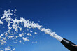 A foam party, a foam cannon against the blue sky. Man ejaculation. Explosion of sperm.