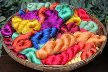 Travel To Bangkok, Thailand. Colorful Threads Of Thai Silk In A Basket Closeup For Background.