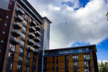 Sticker - Scenic view of residential buildings on a cloudy sky background