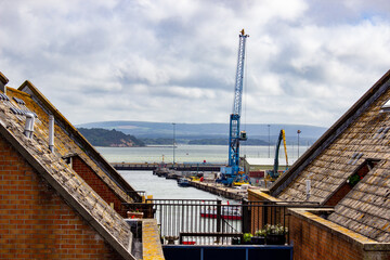 Sticker - Scenic view of a crane in a harbor on a cloudy sky background