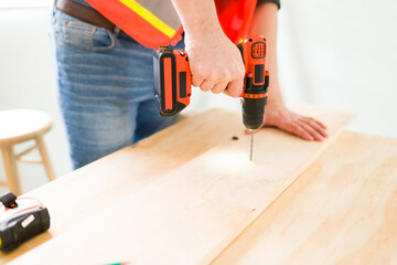 Wall Mural - Close up of the male carpenter hands working with wood