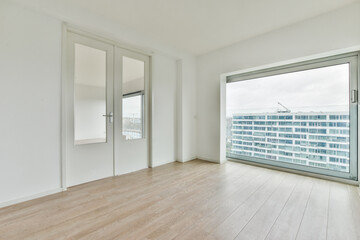 Canvas Print - Empty white room with a door, large windows and laminate flooring