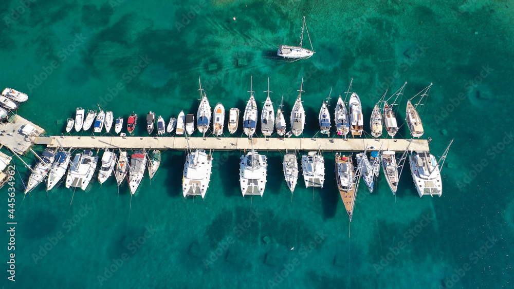 Aerial drone top down photo of exotic island marina with emerald clear sea a safe anchorage for yachts and sailboats - obrazy, fototapety, plakaty 
