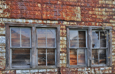 Canvas Print - broken windows in an old, metal building.