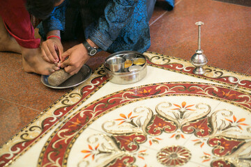 Wall Mural - Indian traditional wedding ritual of putting a toe ring on a bride