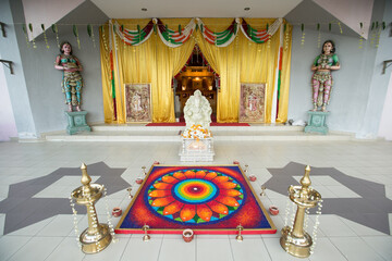 Wall Mural - Traditional Hindu temple decorated for a wedding with brass oil lamps and statues