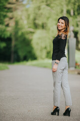 Poster - Vertical shot of a Caucasian businesswoman with elegant clothes walking on a street