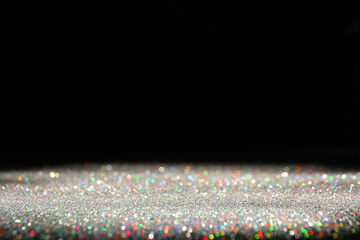 Wall Mural - shiny colorful glitter on black background, space for text. bokeh effect
