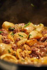 Canvas Print - Lamb with lemon, artichokes and coriander stalks are fried over low heat in cauldron