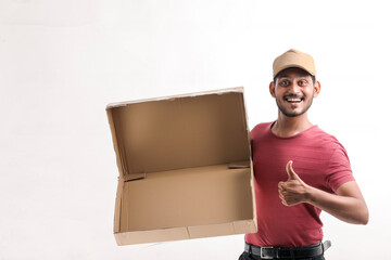 Happy Asian man in t-shirt and cap holding empty box isolated over white background, Delivery service concept